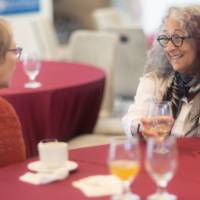 faculty chatting at table